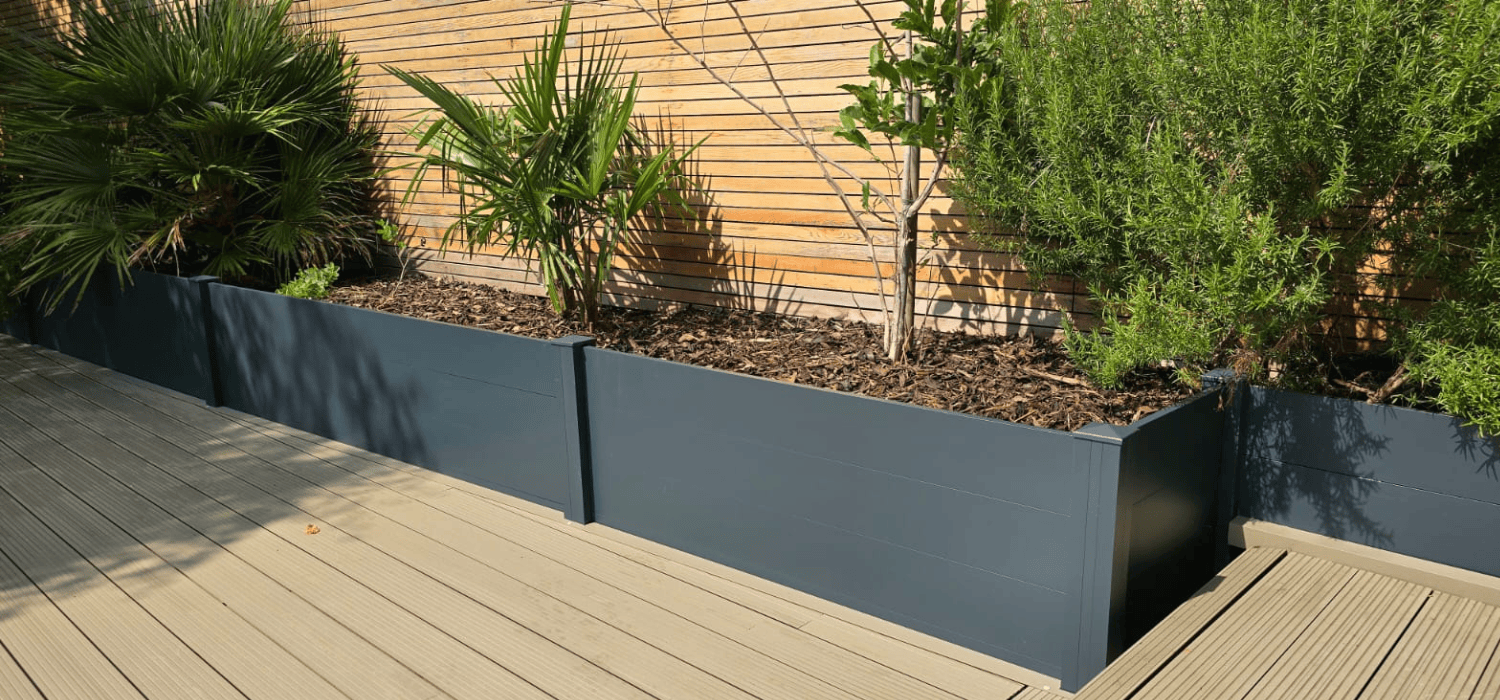 Custom aluminium fencing, modern planters, and stylish gates installed in a residential garden in Bearsted, Maidstone, Kent. The sleek design complements the landscaping.